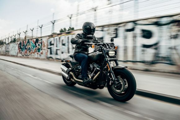 Motorcycle - person riding motorcycle on concrete road