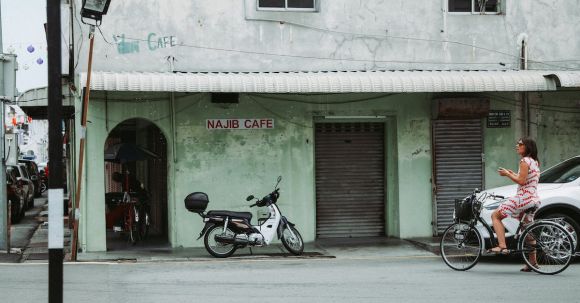 Non-resident Motorcycle License. - Motorcycle parked near shabby building