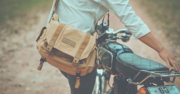 Upgrade Motorcycle License - A Man with a Shoulder Bag Using a Motorcycle