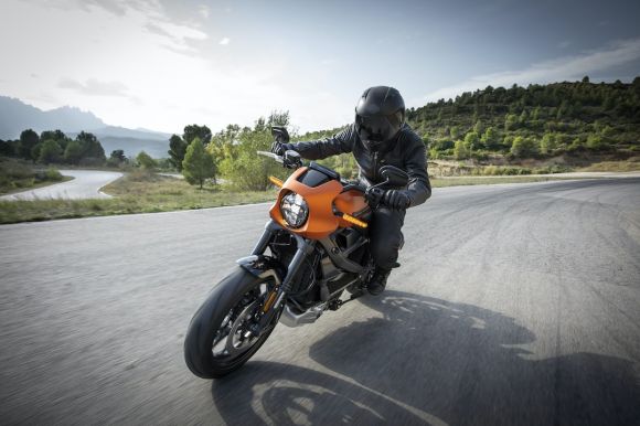 Motorcycle - person driving orange motorcycle