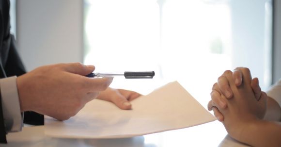 Acceptable Documents - Crop businessman giving contract to woman to sign