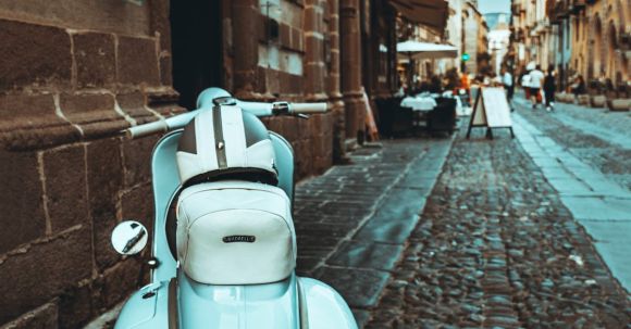 Motorcycle License - Motor Scooter Parked on the Sidewalk