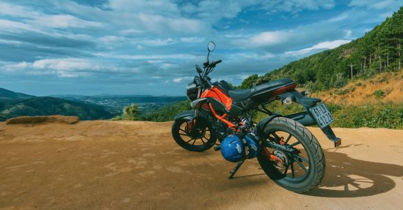 Motorcycle License Requirements - Photography of Orange and Black Sports Motorcycle Near a Cliff