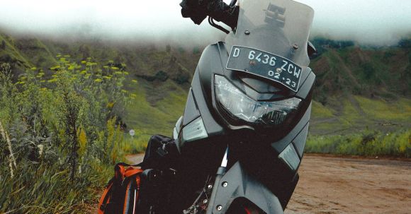 Moto Riding - Modern motorcycle on rural road in green valley