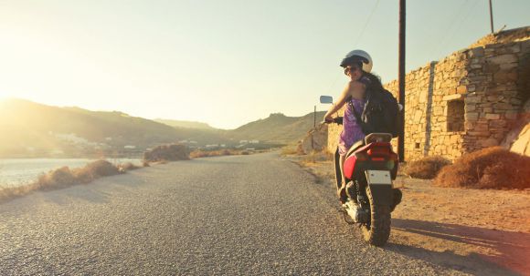 Female Motorcycles. - Woman Riding Motor Scooter Travelling on Asphalt Road during Sunrise