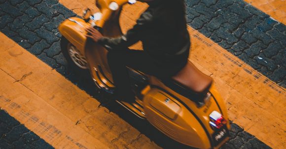 Motorcycle Safety - Person Riding on Yellow Motor Scooter on Road