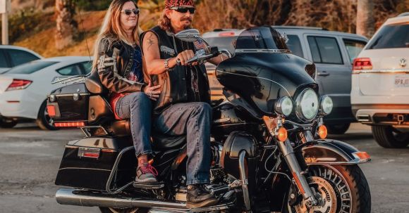 Touring Motorcycle, Commuting. - A Couple Riding a Harley Davidson Touring