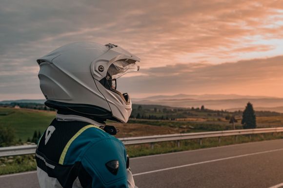 Motorcycle Helmet - person in blue and white jacket wearing white helmet