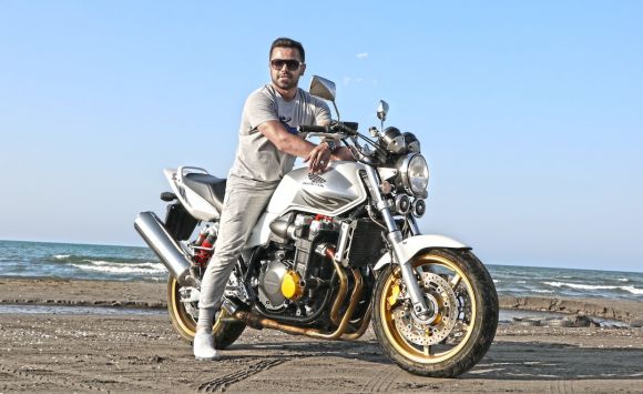 Moto Riding - man riding on motorcycle on shoreline