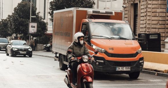 Moto Riding - Rider on motorbike riding on road with cars