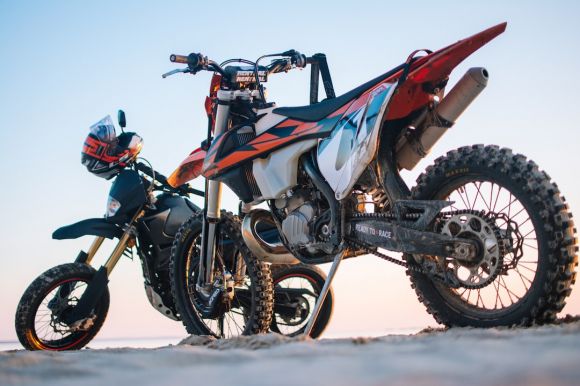 Dirt Bike - selective focus photography of two white and black dual-sport motorcycles