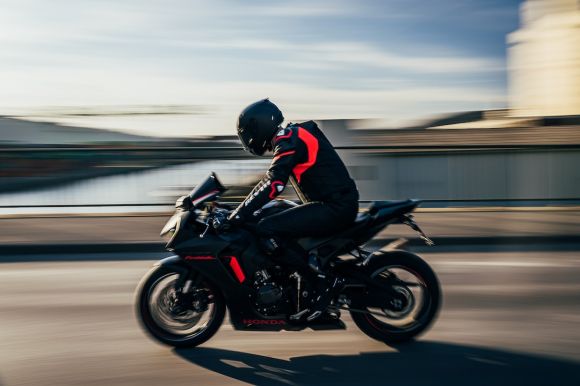 Motorcycle Helmet - man in black helmet riding black sports bike on road during daytime