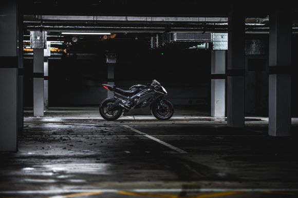 Motorcycle - black sports bike parking in garage area