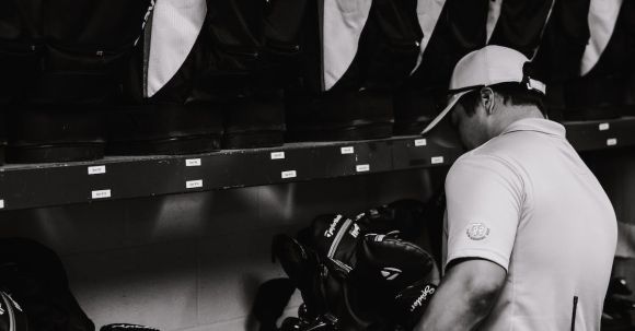 Gear Selection - Man Standing in Front of a Golf Bags