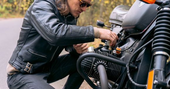 Motorcycle Maintenance - A Biker Checking His Motorbike