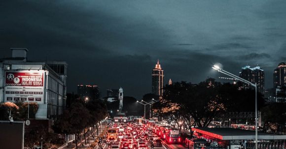 Motorcycle Route Planning - Various vehicles driving on asphalt street during traffic jam in modern city district in evening