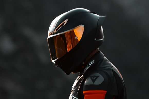 Motorcycle Helmet - black and orange helmet on black motorcycle