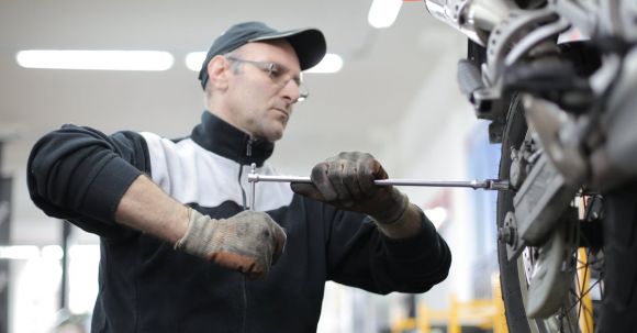 Motorcycle Maintenance - Photo of Man Fixing a Motorcycle