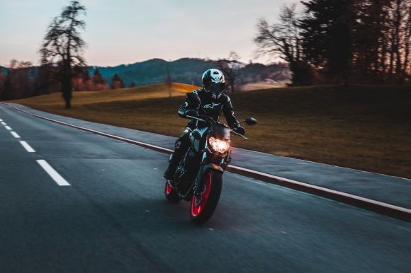 Motorcycle - man in black helmet riding motorcycle on road during daytime