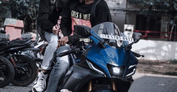 Two People On A Motorcycle - Two People in Helmets Seated on Motorcycle in Street