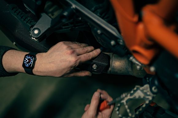 Motorcycle Maintenance - a close up of a person working on a motorcycle