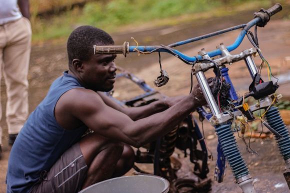 Moto Maintenance - man fixing motorcycle during daytime