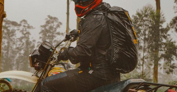 Moto Riding - Male motorcyclist in helmet riding in forest