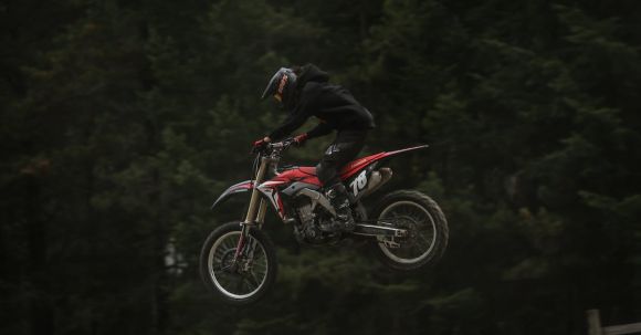 Moto Riding - Racer Jumping a Motorcycle in the Air