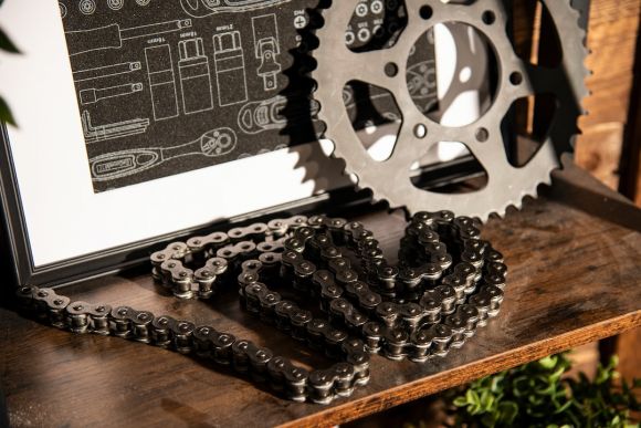 Moto Gear - a bike chain and a picture frame on a table