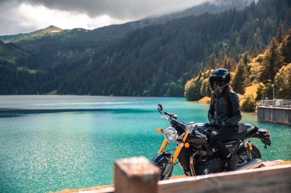 Motorcycle Trip - man in black jacket riding motorcycle near body of water during daytime