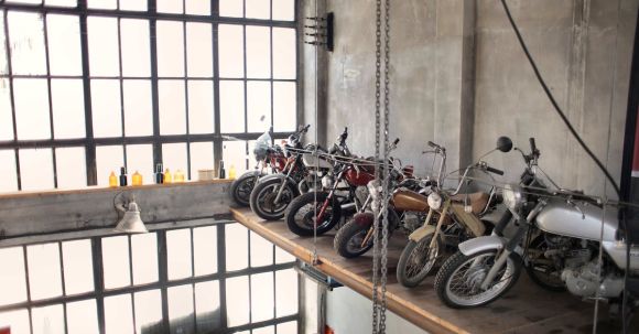 Motorcycle Storage. - Retro motorbikes parked in row on special platform in garage
