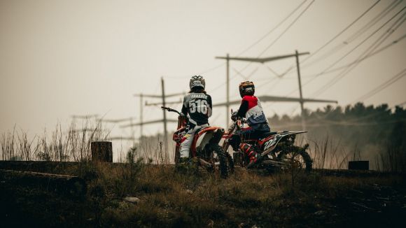 Off-road Moto Riding - man in black helmet riding red motorcycle