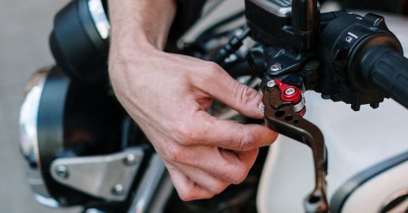 Brake Maintenance - Person Fixing the Brake of a Motorcycle