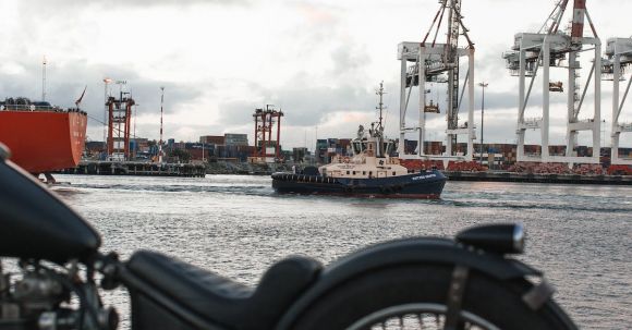 Moto Maintenance - Motorbike parked next to seaport