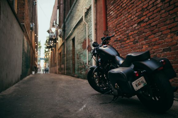 Motorcycle Maintenance - black cruiser motorcycle parked at the middle of the alley