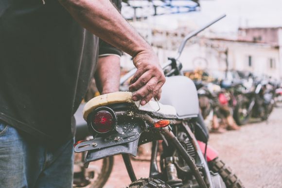 Moto Hand - person holding the motorcycle