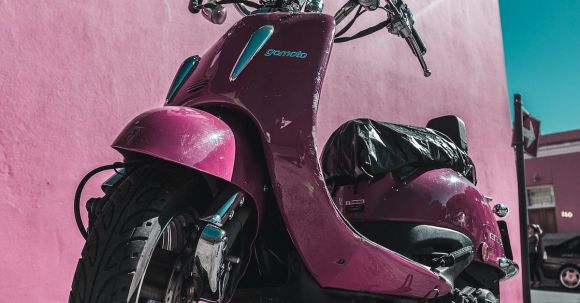 Motorcycle Insurance - Pink Motor Scooter Parked Beside Pink Concrete Wall