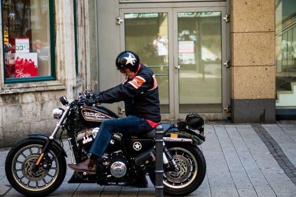 Motorcycle Jackets - man riding black cruiser motorcycle