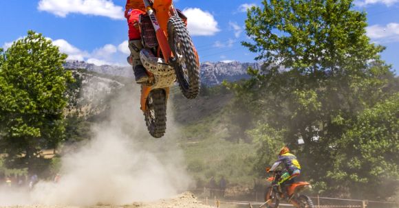 Off-road Skills - A Man Jumping a Ramp in a Motocross