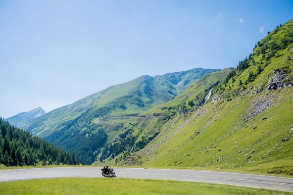 Grass Moto Riding - gray concrete roadway under blue sky