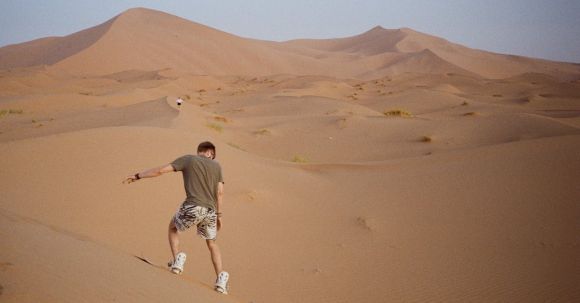 Sand Dune Riding - Man Riding Dune on Sandboard