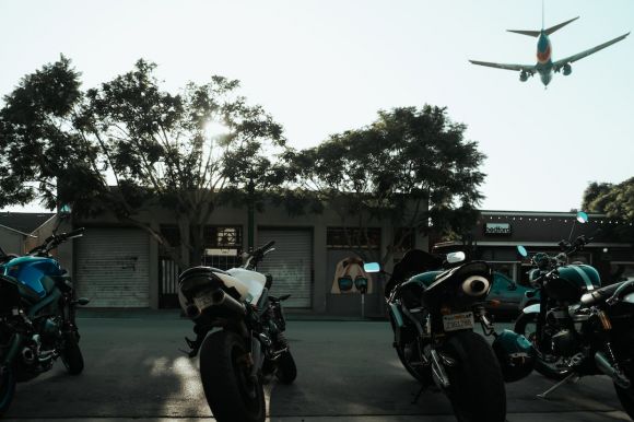 Moto Riding - motorcycles parked on concrete pavement