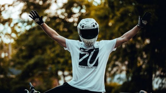Moto Riding - man in white and black nike crew neck t-shirt wearing black and white helmet