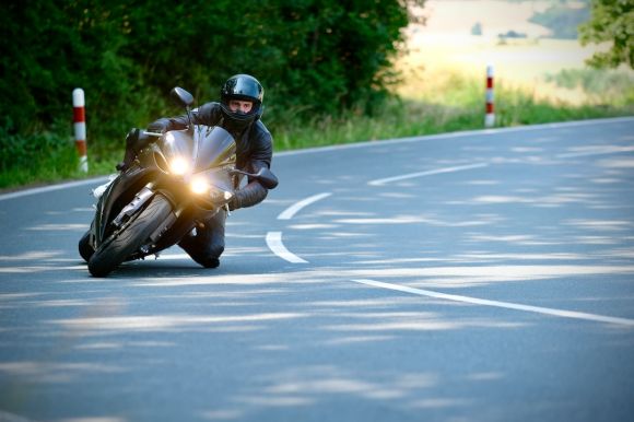 Motorcycle Tires - a man riding a motorcycle down a curvy road