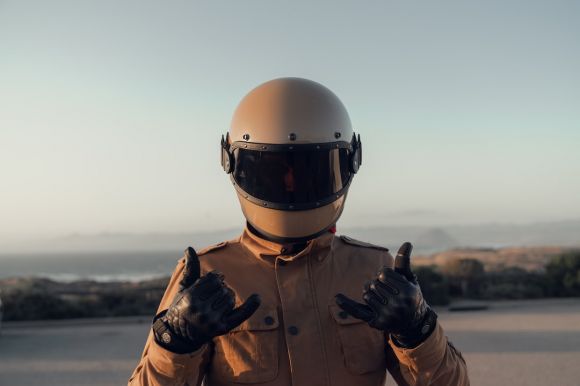 Motorcycle Helmet - person in black jacket wearing white helmet