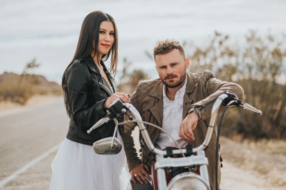 Motorcycle Jackets - man sitting on motorcycle beside woman