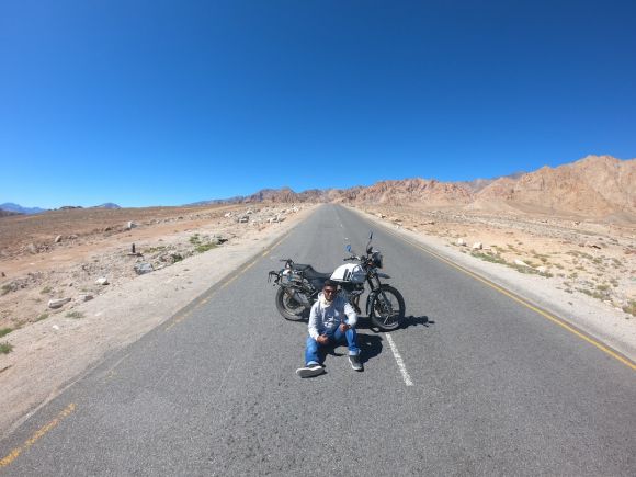 Motorcycle Footwear - man sitting on road near motorcycle during daytime