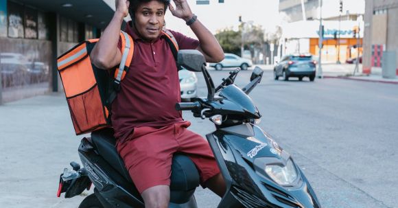 Motorcycle Goggles - Deliveryman Sitting on a Scooter