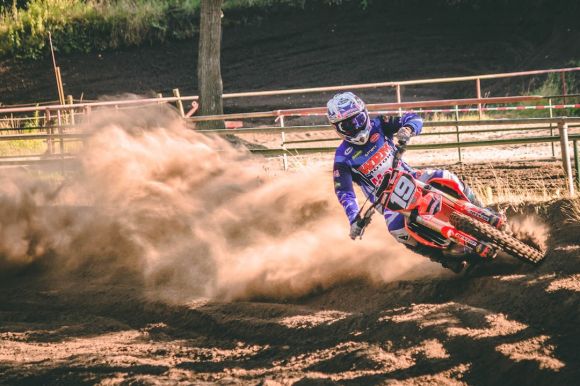 Dirt Bike - person riding on motocross dirt bike drifts on race track