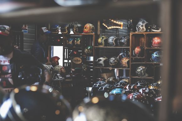 Motorcycle Helmet - helmets in shelves and on table inside room